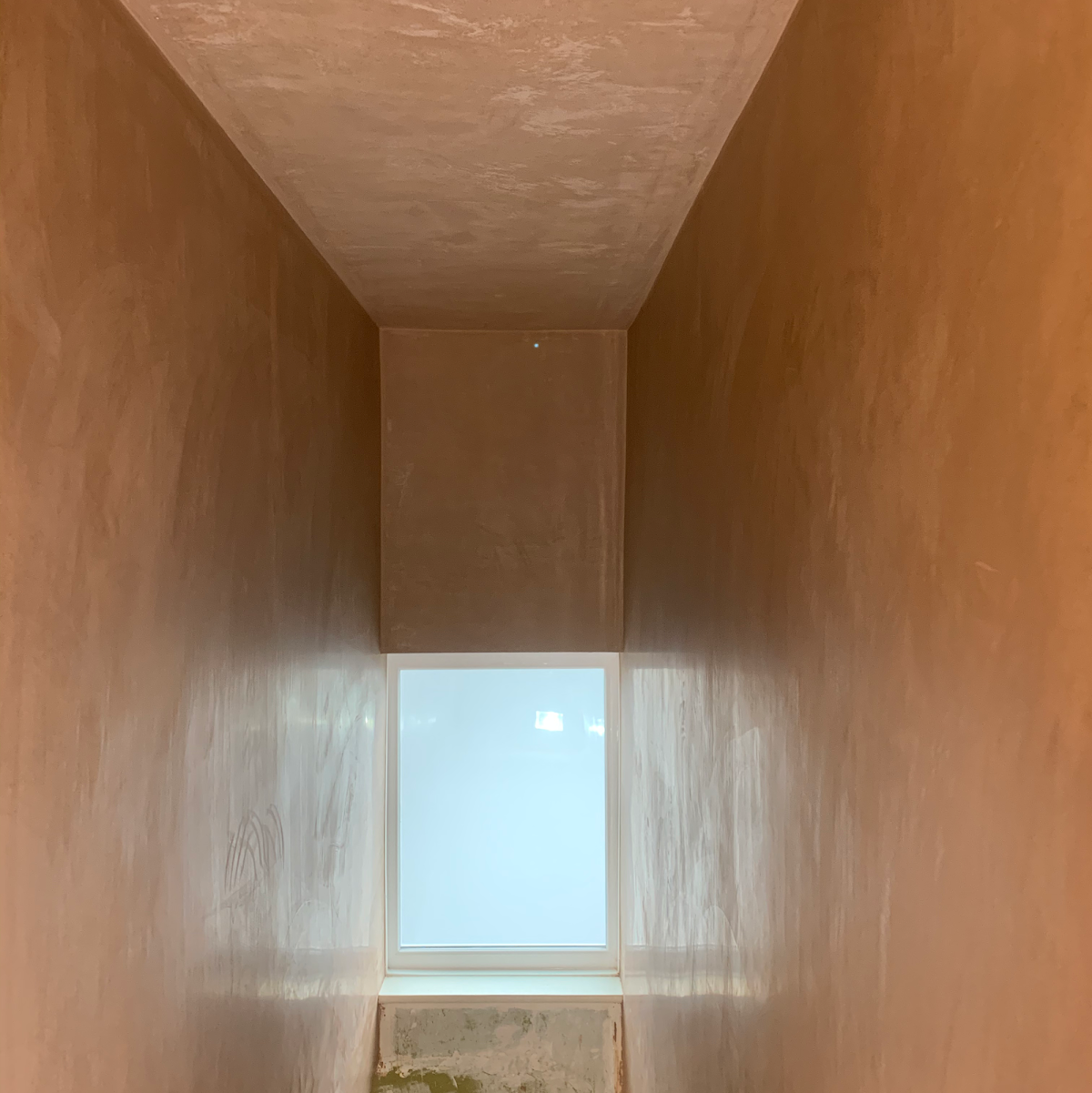 Stairwell window reveal freshly plastered